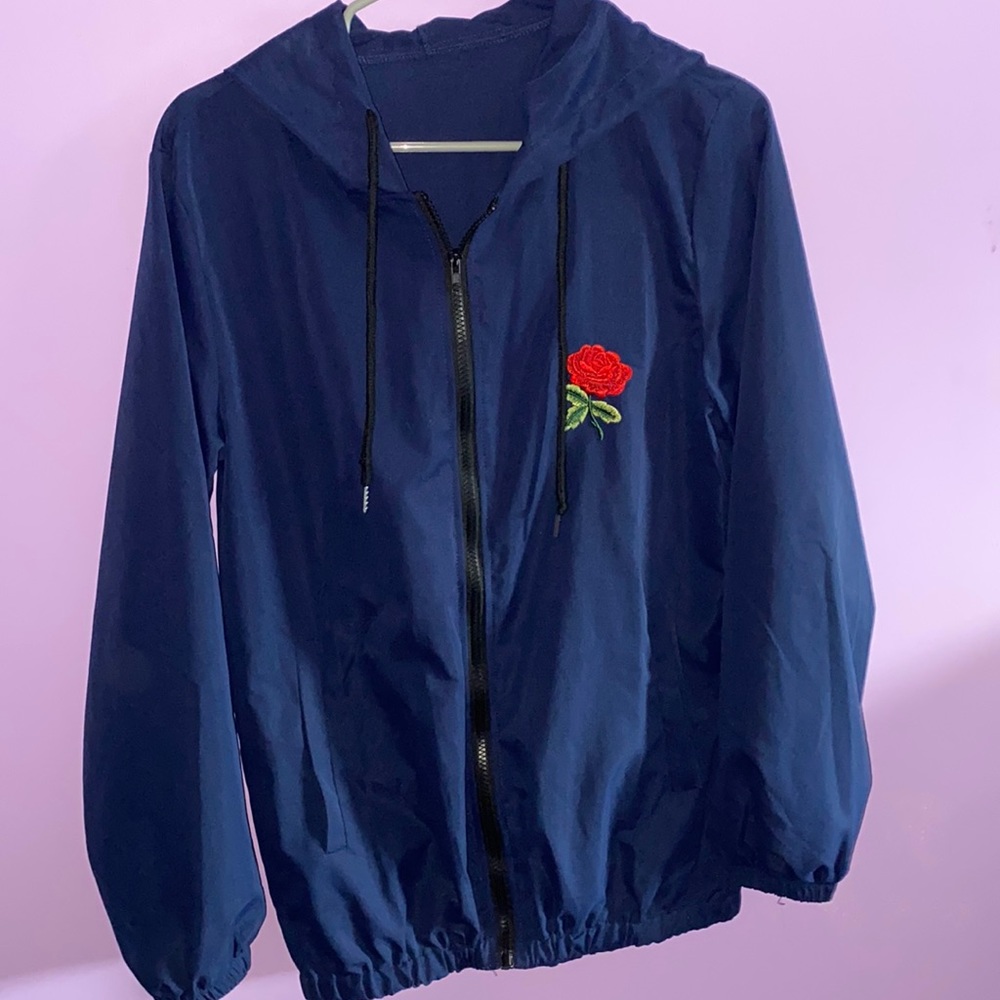 Wind breaker navy blue zip up hoodie with a rose on the front.